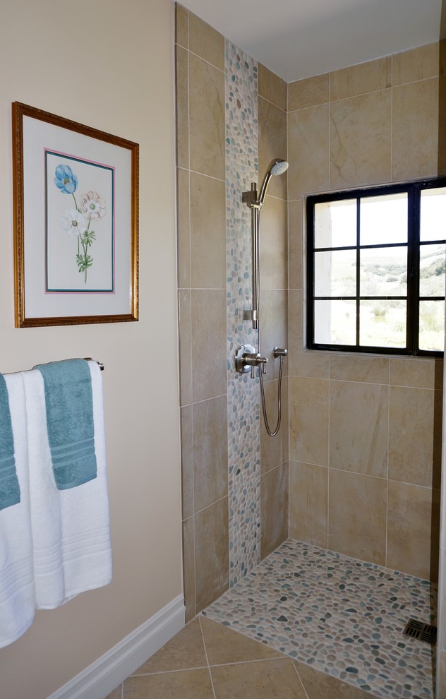 This is an example of a small beach style bathroom in Santa Barbara with an open shower, beige tile, beige walls, ceramic floors and pebble tile.