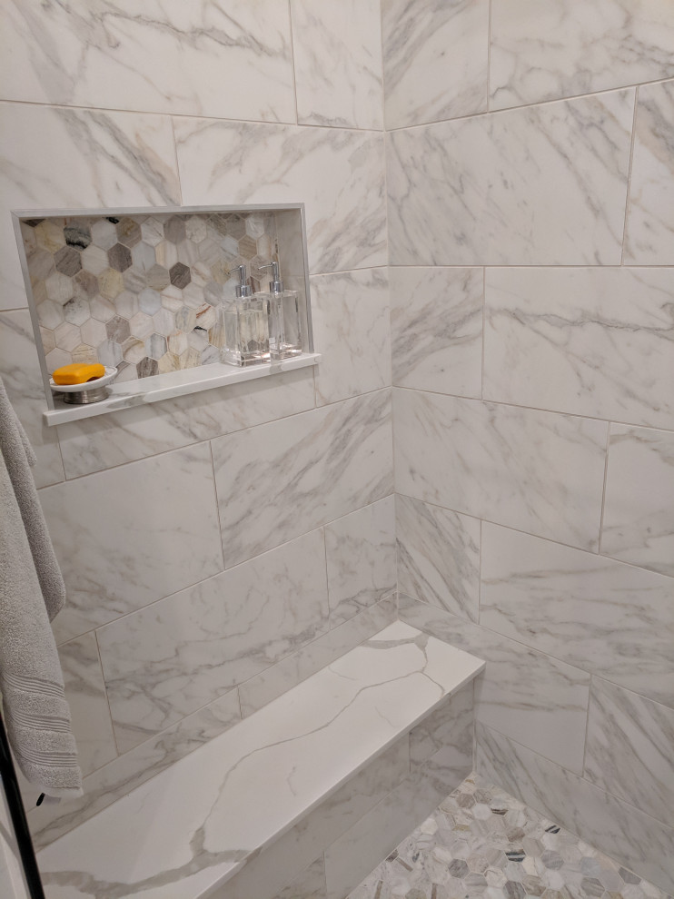 Design ideas for a mid-sized transitional master bathroom in Cleveland with recessed-panel cabinets, brown cabinets, a freestanding tub, an alcove shower, a two-piece toilet, white tile, marble, grey walls, marble floors, an undermount sink, engineered quartz benchtops, grey floor, a hinged shower door, white benchtops, a double vanity and a freestanding vanity.