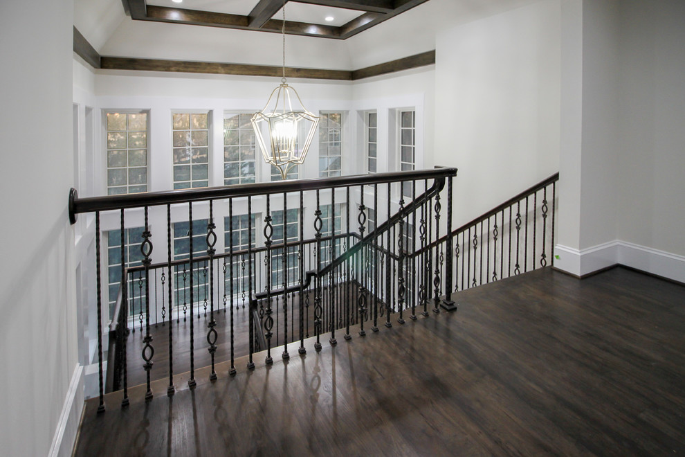 Photo of a large transitional wood floating staircase in DC Metro with wood risers and glass railing.