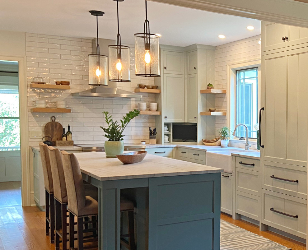 This is an example of a transitional l-shaped eat-in kitchen in Philadelphia with quartzite benchtops, white splashback and with island.