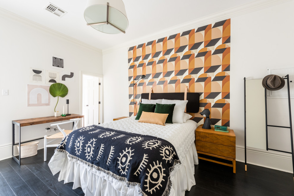 Design ideas for a mid-sized eclectic guest bedroom in New Orleans with white walls, dark hardwood floors and black floor.