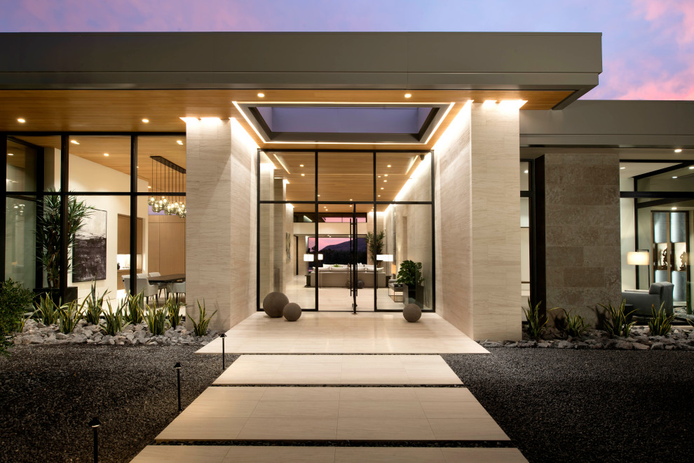 Entryway - huge contemporary limestone floor and wood ceiling entryway idea in Phoenix with a glass front door
