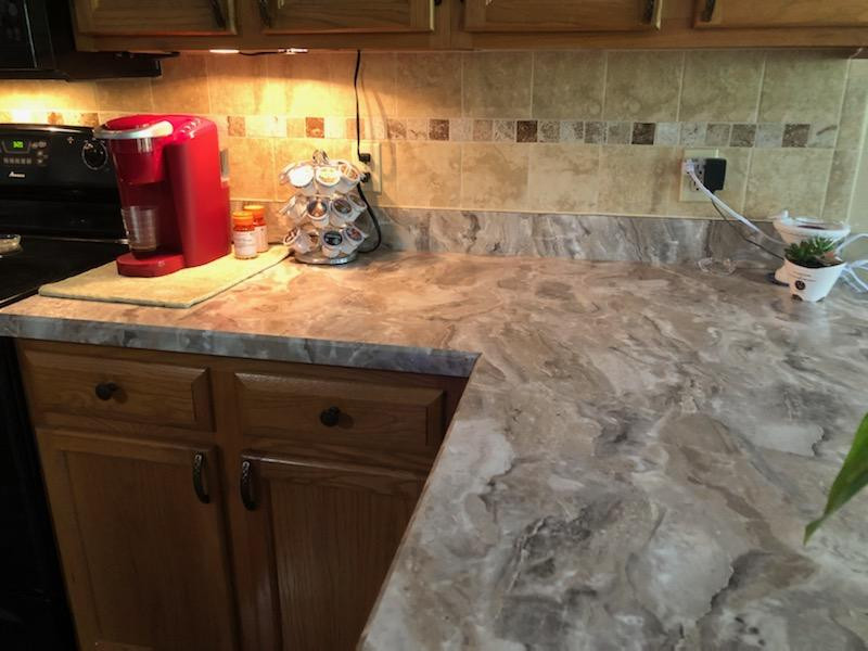 Example of a mid-sized kitchen design with laminate countertops and gray countertops