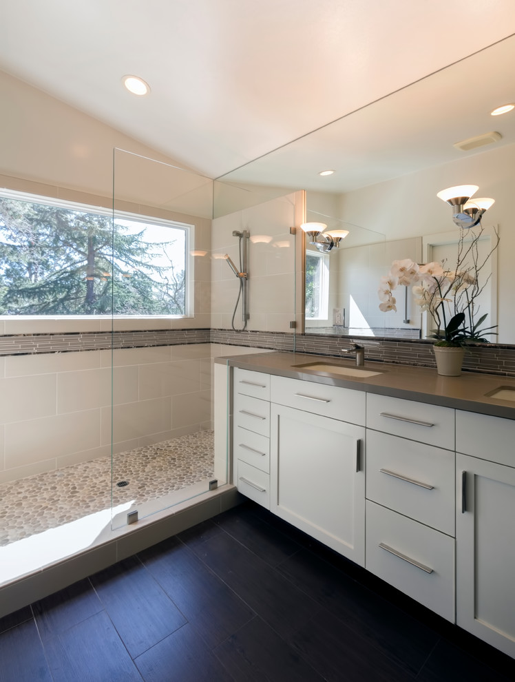 This is an example of a large transitional master bathroom in San Francisco with shaker cabinets, white cabinets, a corner shower, beige tile, gray tile, porcelain tile, beige walls, dark hardwood floors, an undermount sink, concrete benchtops, brown floor, an open shower and grey benchtops.