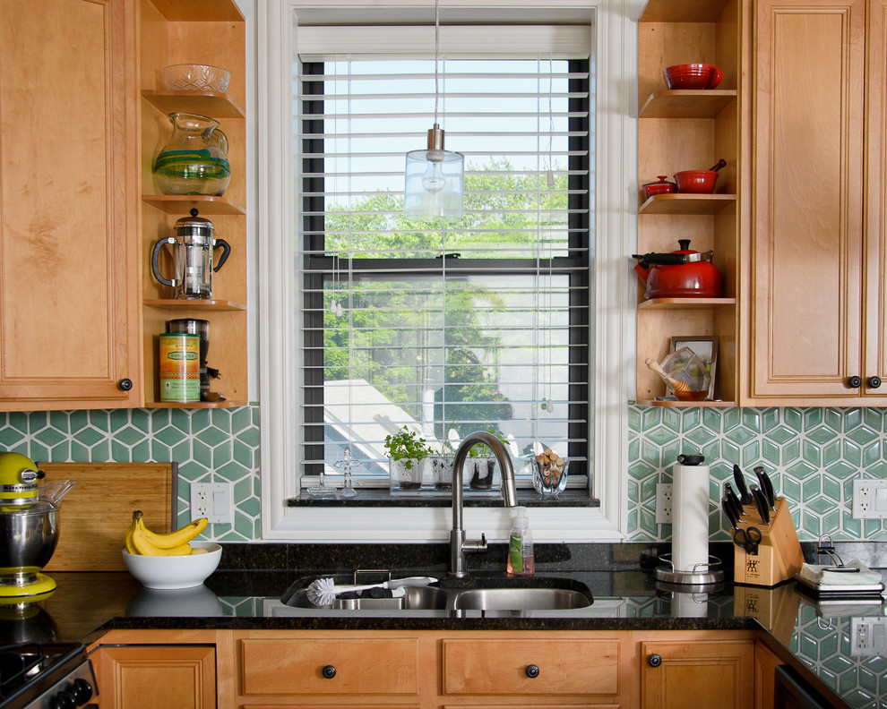 Eat-in kitchen - mid-sized transitional u-shaped medium tone wood floor eat-in kitchen idea in Chicago with an undermount sink, raised-panel cabinets, medium tone wood cabinets, granite countertops, green backsplash, porcelain backsplash, stainless steel appliances and a peninsula