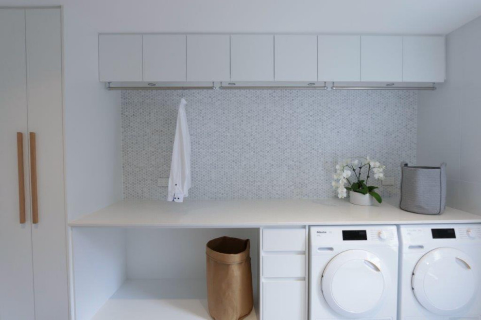 Photo of a medium sized contemporary galley utility room in Sydney with a submerged sink, mosaic tiled splashback, ceramic flooring and a side by side washer and dryer.