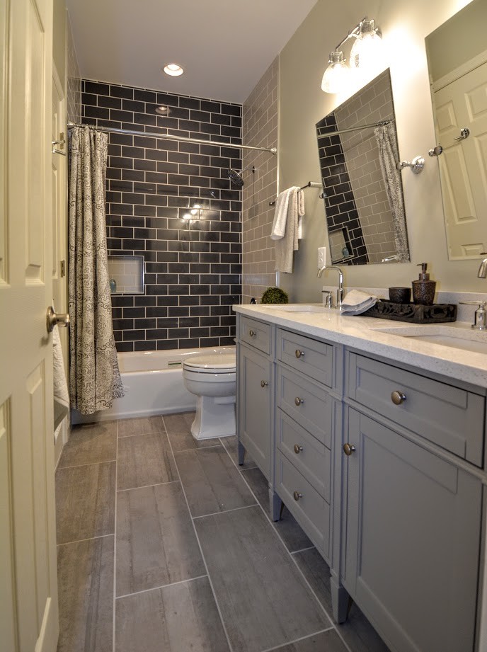 Mid-sized transitional kids bathroom in Richmond with a drop-in tub, a two-piece toilet, multi-coloured tile, ceramic tile, green walls, porcelain floors, an undermount sink, quartzite benchtops and brown floor.