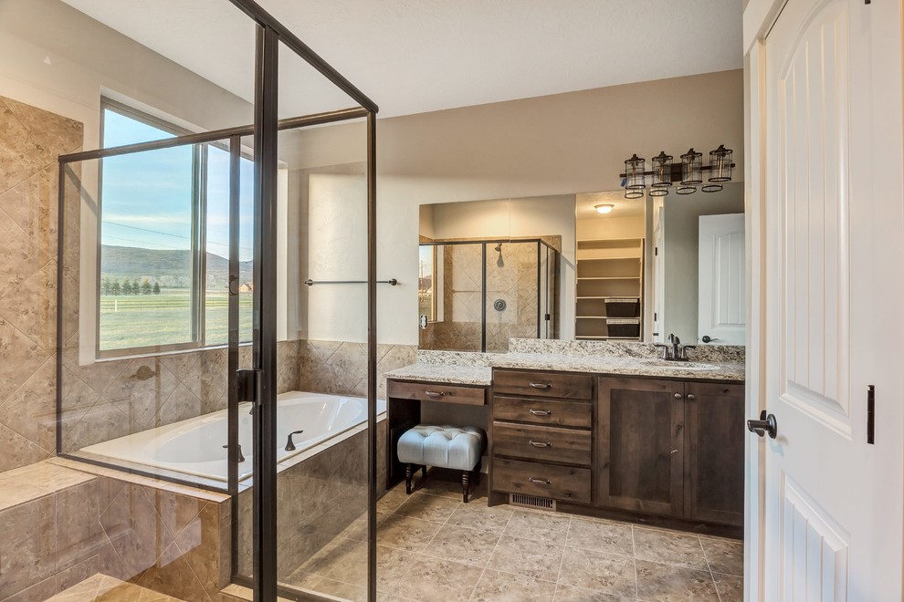 Design ideas for a mid-sized country master bathroom in Salt Lake City with shaker cabinets, distressed cabinets, an alcove tub, an alcove shower, a two-piece toilet, brown tile, ceramic tile, beige walls, ceramic floors, an undermount sink, granite benchtops, brown floor and a hinged shower door.