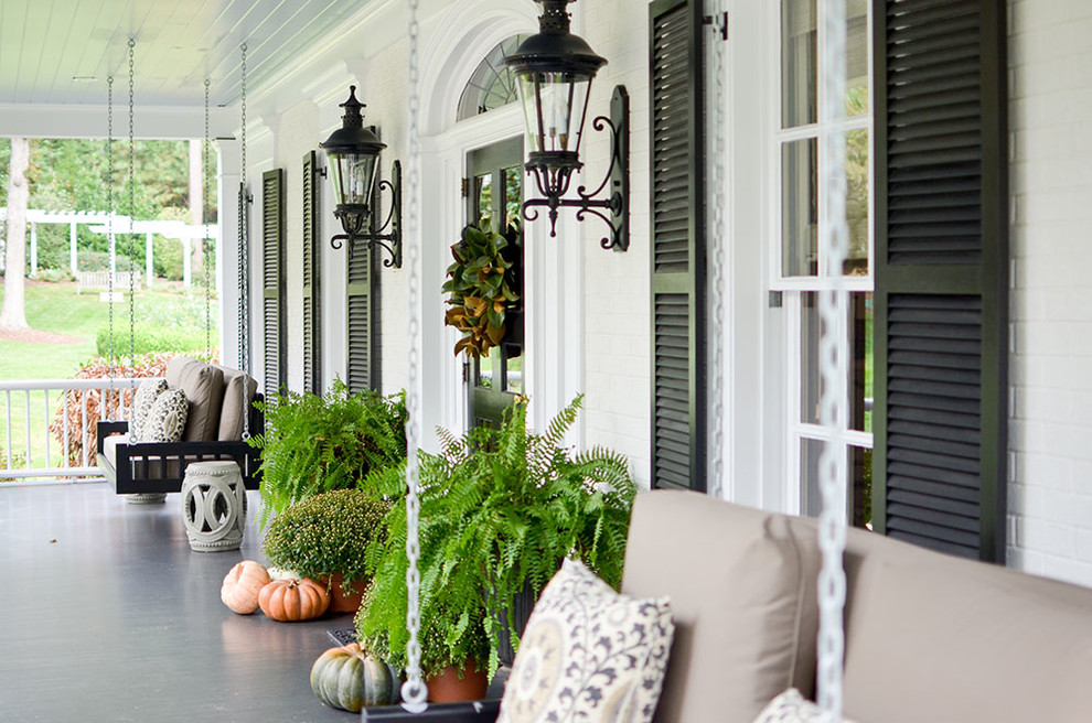 Inspiration for a traditional verandah in Raleigh with a roof extension and a container garden.