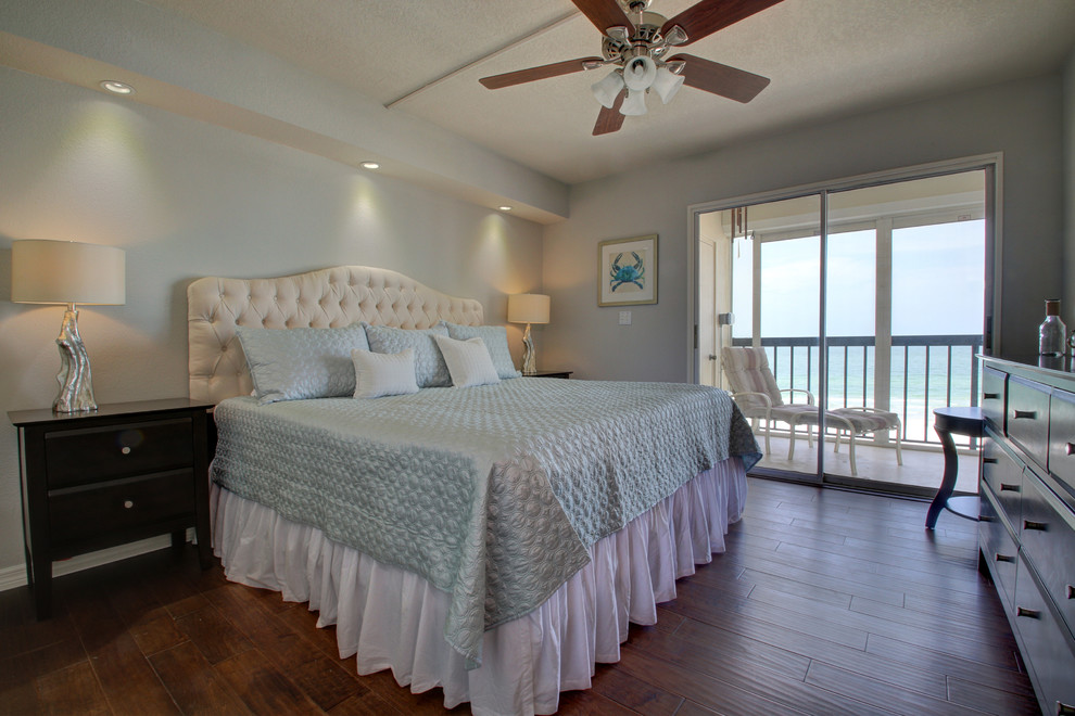 Inspiration for a small beach style master bedroom in Tampa with grey walls, dark hardwood floors and no fireplace.