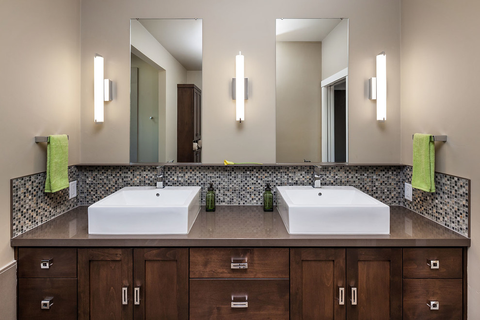This is an example of a large modern master bathroom in Portland with a vessel sink, dark wood cabinets, engineered quartz benchtops, mosaic tile, shaker cabinets, an alcove tub, an alcove shower, multi-coloured tile, beige walls and porcelain floors.