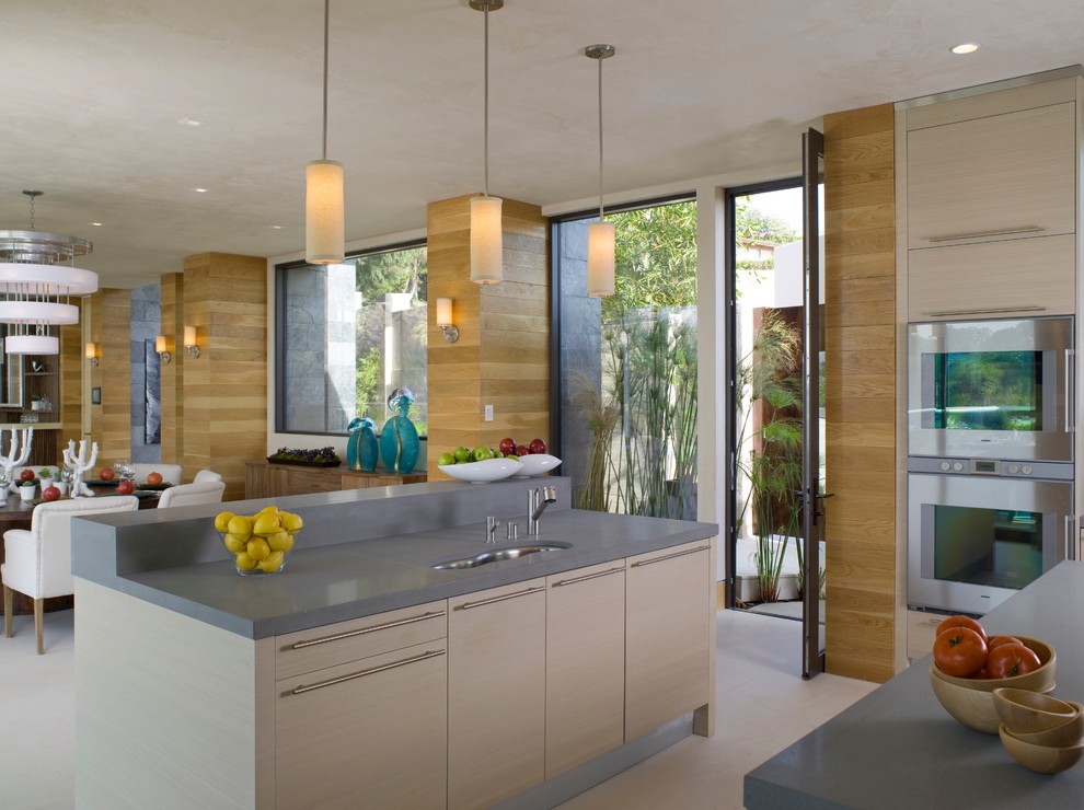 Inspiration for a contemporary open plan kitchen in Los Angeles with flat-panel cabinets and light wood cabinets.