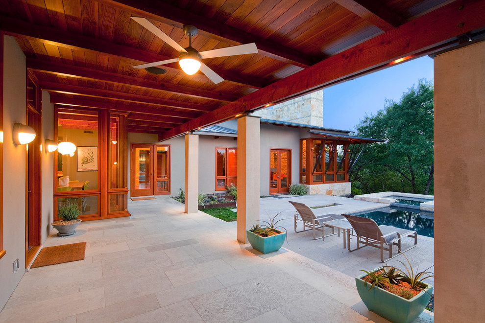 Inspiration for a contemporary patio in Austin with a roof extension.
