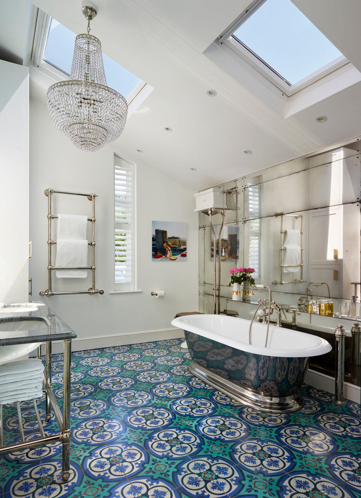 Victorian master bathroom in London with a freestanding tub, multi-coloured tile, white walls and turquoise floor.