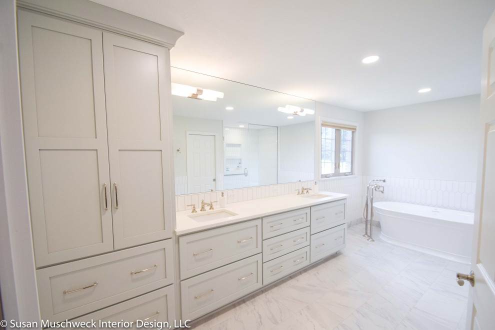 Example of a large transitional master white tile and ceramic tile porcelain tile, white floor and double-sink freestanding bathtub design with shaker cabinets, gray cabinets, white walls, an undermount sink, quartz countertops, a hinged shower door, white countertops and a built-in vanity