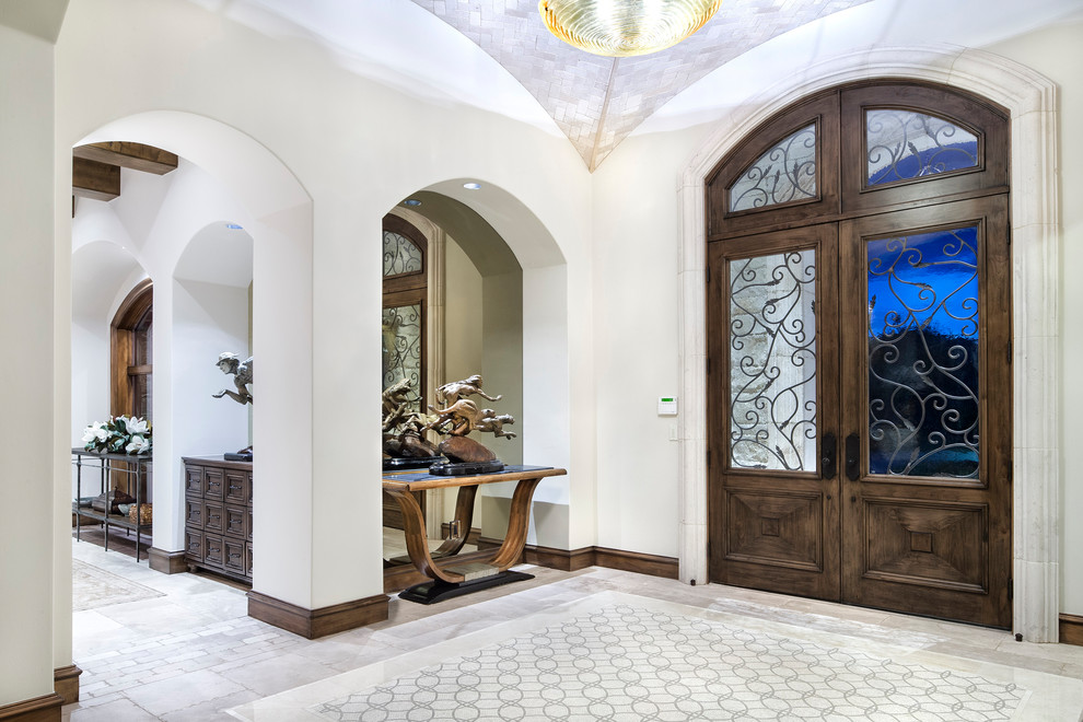 Photo of a large traditional foyer in Austin with white walls, marble floors, a double front door and a medium wood front door.