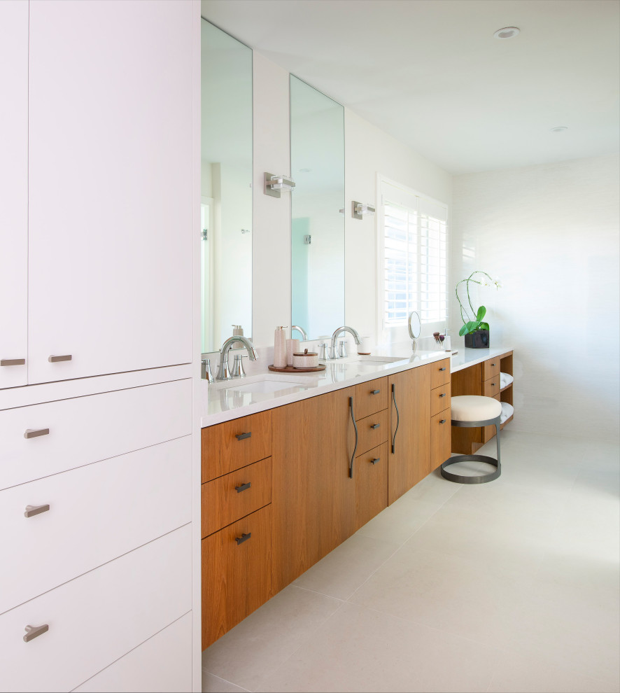 Example of a mid-sized trendy master white tile and porcelain tile porcelain tile, white floor, double-sink and wood wall bathroom design in Dallas with flat-panel cabinets, medium tone wood cabinets, a one-piece toilet, gray walls, an undermount sink, quartz countertops, a hinged shower door, white countertops and a floating vanity
