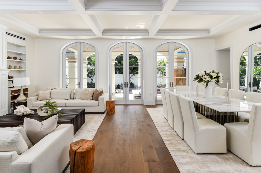 Design ideas for an expansive transitional open plan dining in Miami with dark hardwood floors, a standard fireplace, a stone fireplace surround, brown floor, recessed and white walls.
