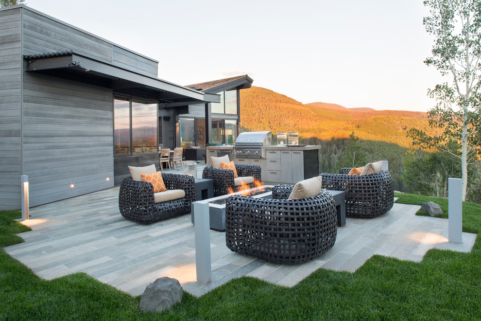 This is an example of a contemporary patio in Denver with a fire feature and no cover.