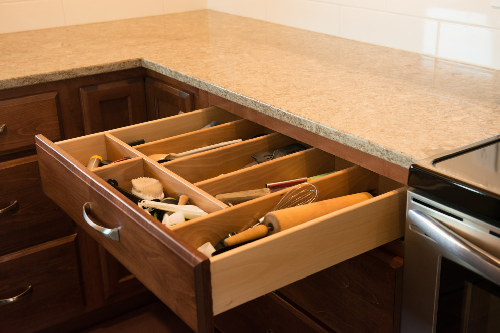 Large transitional l-shaped medium tone wood floor open concept kitchen photo with an undermount sink, flat-panel cabinets, medium tone wood cabinets, quartz countertops, white backsplash, ceramic backsplash, stainless steel appliances, an island and multicolored countertops