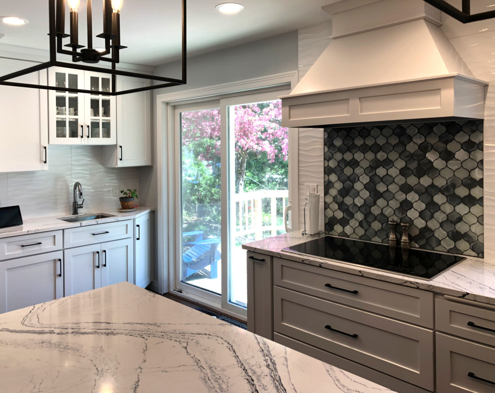Kitchen - transitional l-shaped medium tone wood floor kitchen idea with an undermount sink, shaker cabinets, white cabinets, quartz countertops, multicolored backsplash, ceramic backsplash, stainless steel appliances, an island and multicolored countertops