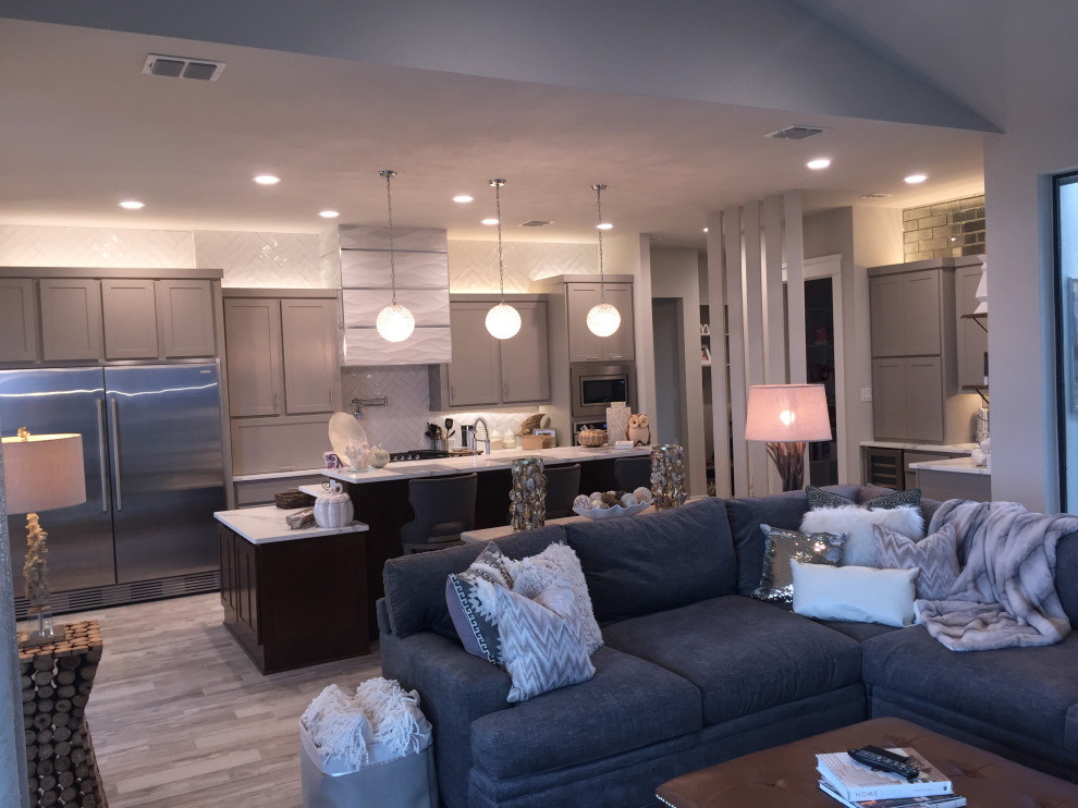 Eat-in kitchen - mid-sized transitional single-wall porcelain tile and beige floor eat-in kitchen idea with an undermount sink, shaker cabinets, gray cabinets, quartzite countertops, white backsplash, ceramic backsplash, stainless steel appliances, two islands and white countertops