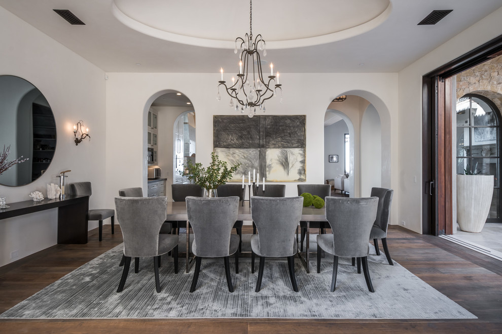 Design ideas for a mediterranean dining room in Los Angeles with beige walls, dark hardwood floors and brown floor.