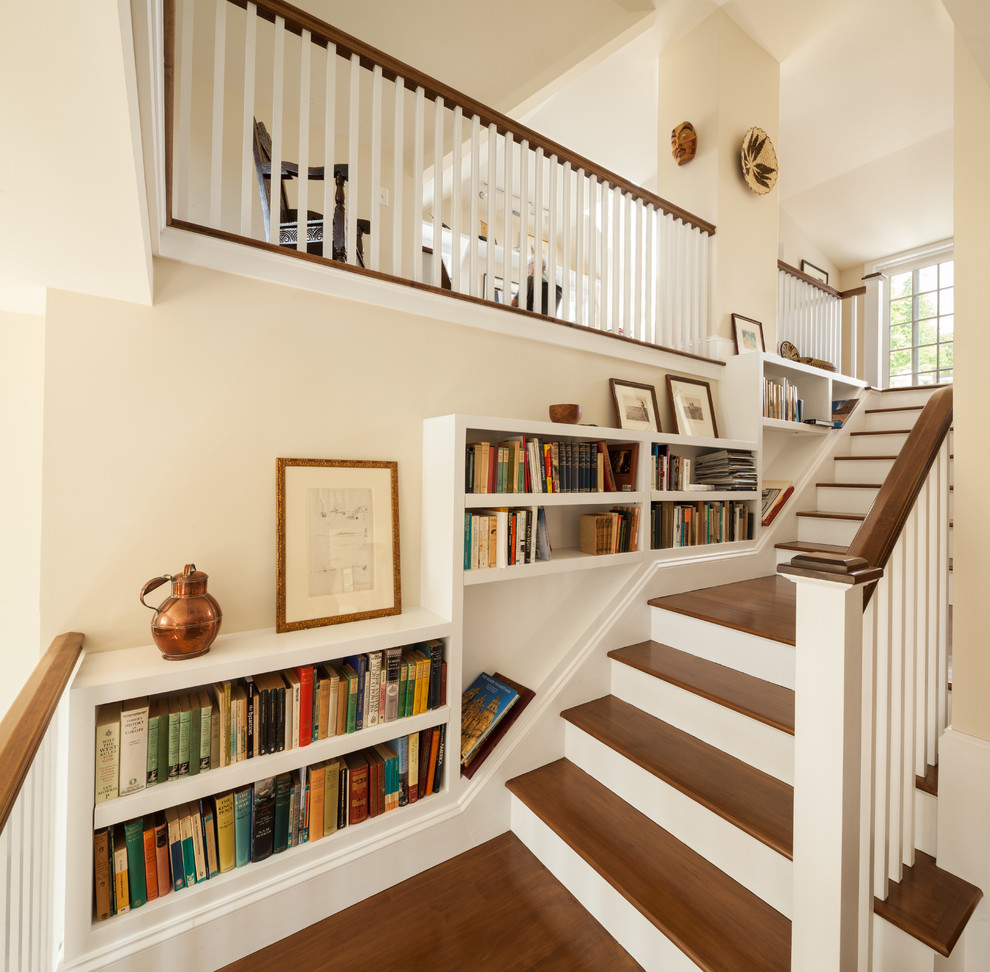 Photo of a mid-sized traditional wood l-shaped staircase in Boston with painted wood risers and wood railing.