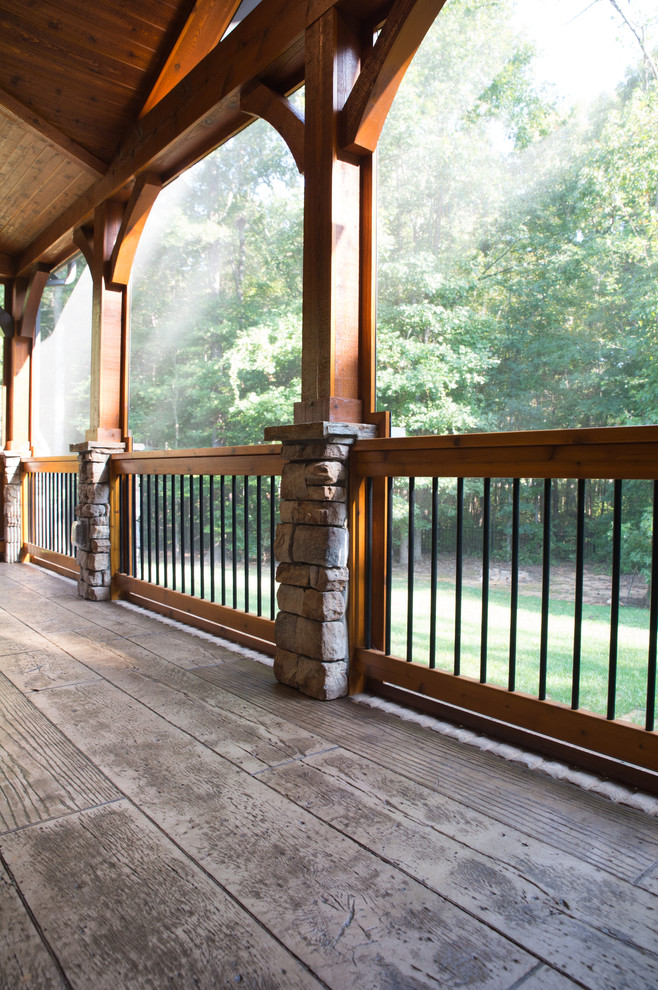 Inspiration for a large country backyard screened-in verandah in Charlotte with stamped concrete and a roof extension.