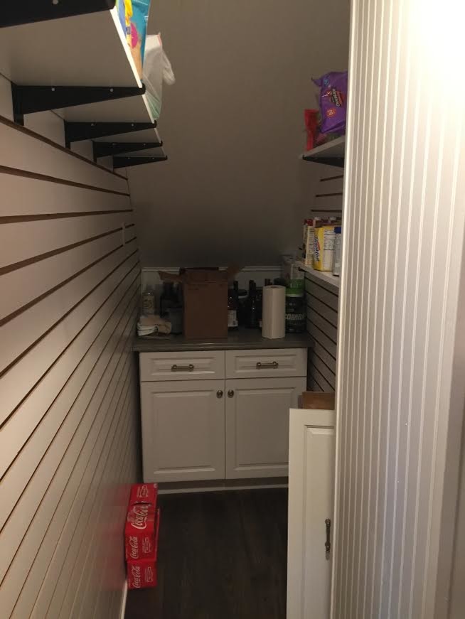 Large transitional l-shaped dark wood floor and brown floor enclosed kitchen photo in Tampa with raised-panel cabinets, white cabinets, stainless steel appliances and an island
