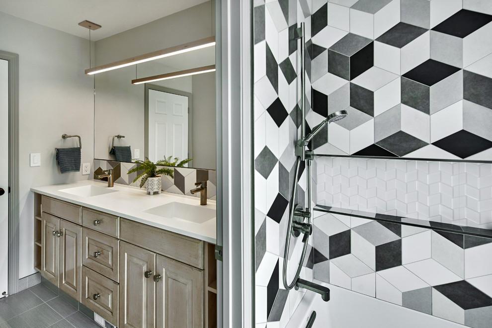 Design ideas for a mid-sized transitional kids bathroom in San Francisco with raised-panel cabinets, light wood cabinets, an alcove tub, a shower/bathtub combo, a one-piece toilet, black and white tile, ceramic tile, grey walls, ceramic floors, an integrated sink, solid surface benchtops, grey floor, a shower curtain and white benchtops.