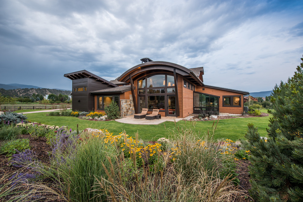 Country exterior in Denver with wood siding.