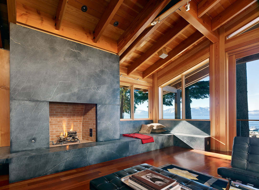 This is an example of a contemporary living room in San Francisco with dark hardwood floors and a standard fireplace.