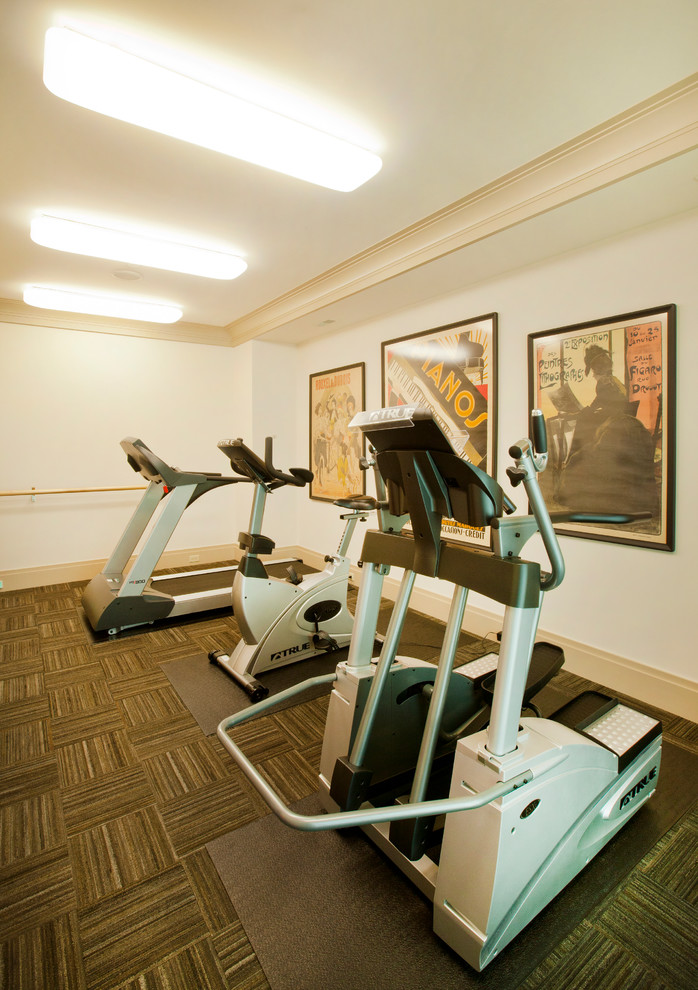 This is an example of a large contemporary multipurpose gym in Omaha with white walls and carpet.