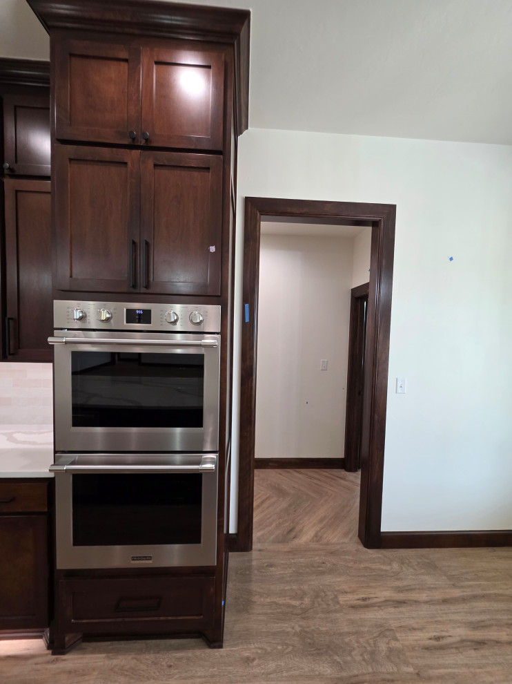 Double ovens complete the kitchen. The opening is the entrance to primary suite 