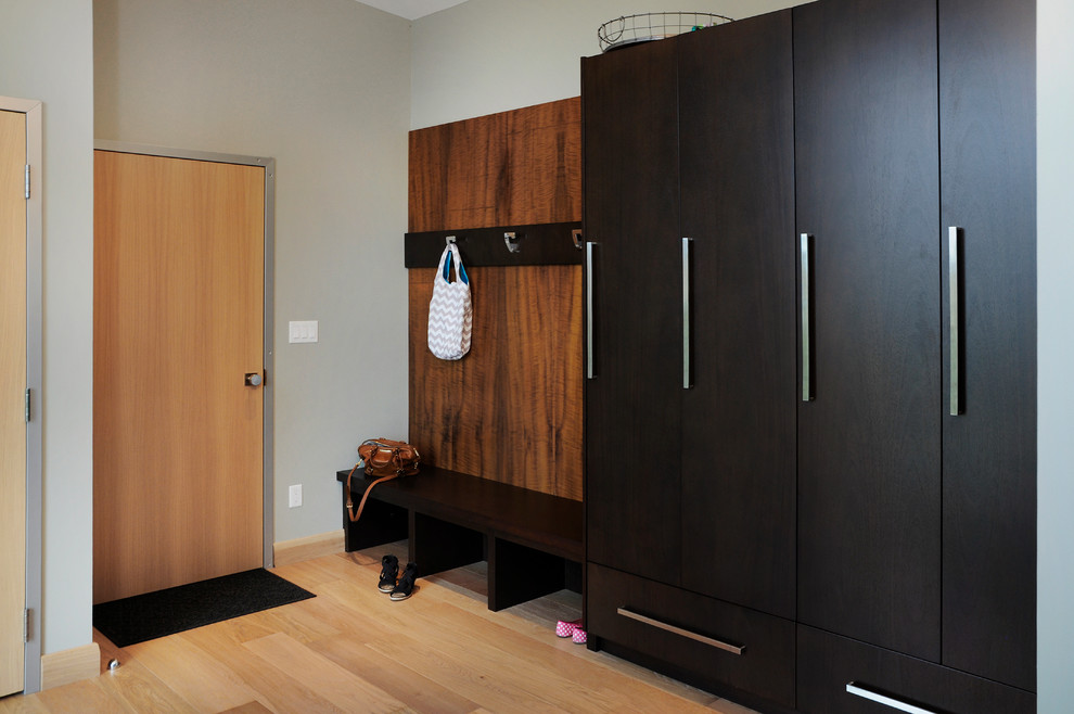 Photo of a large contemporary mudroom in Toronto with grey walls and light hardwood floors.
