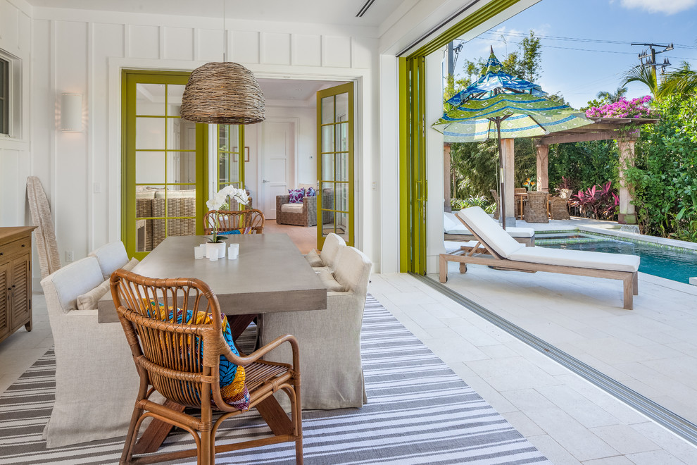 Mid-sized beach style separate dining room in Miami with white walls, limestone floors and white floor.
