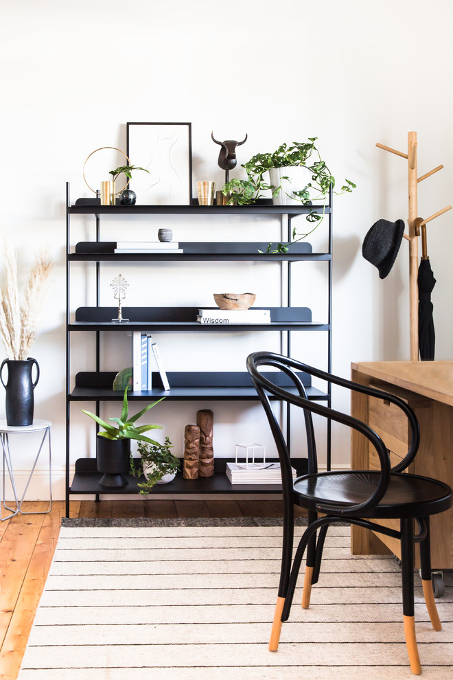 Photo of a transitional study room in Melbourne with white walls, medium hardwood floors, a freestanding desk and beige floor.