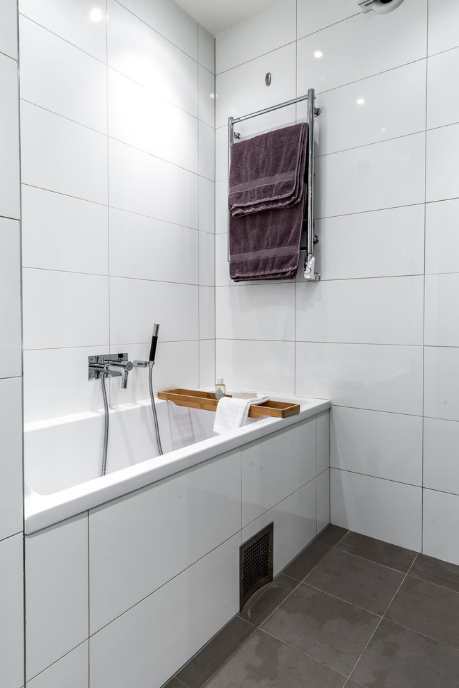 This is an example of a modern bathroom in Stockholm with a drop-in tub.