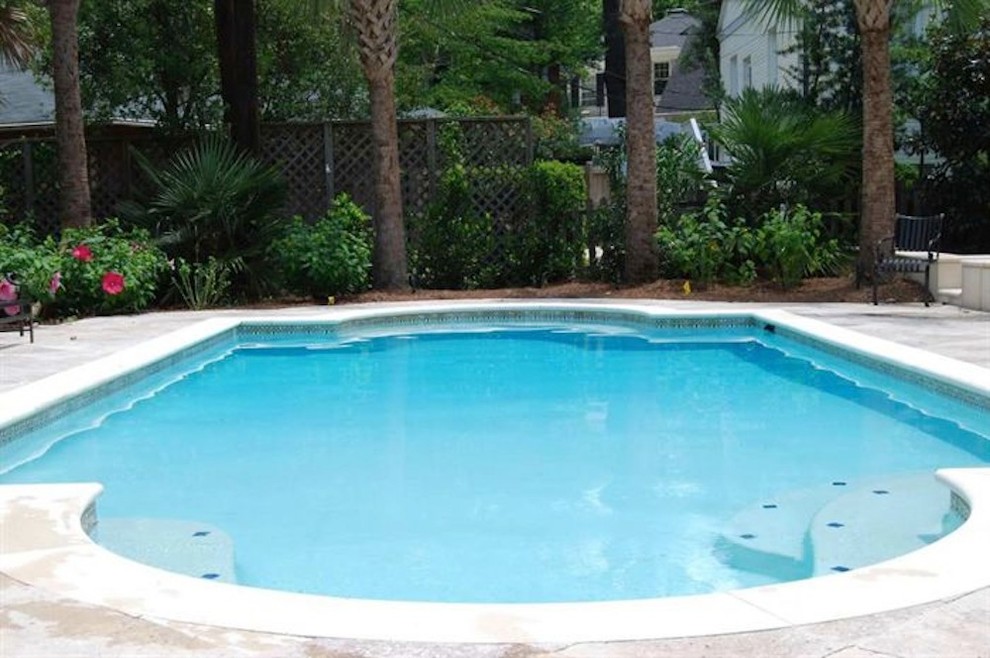 Pool fountain - mid-sized backyard stone and rectangular natural pool fountain idea