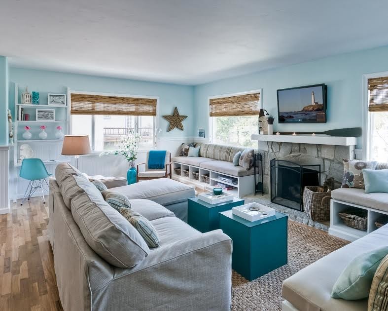 Inspiration for a mid-sized beach style formal enclosed living room in Phoenix with blue walls, light hardwood floors, a standard fireplace, a stone fireplace surround, a wall-mounted tv and beige floor.