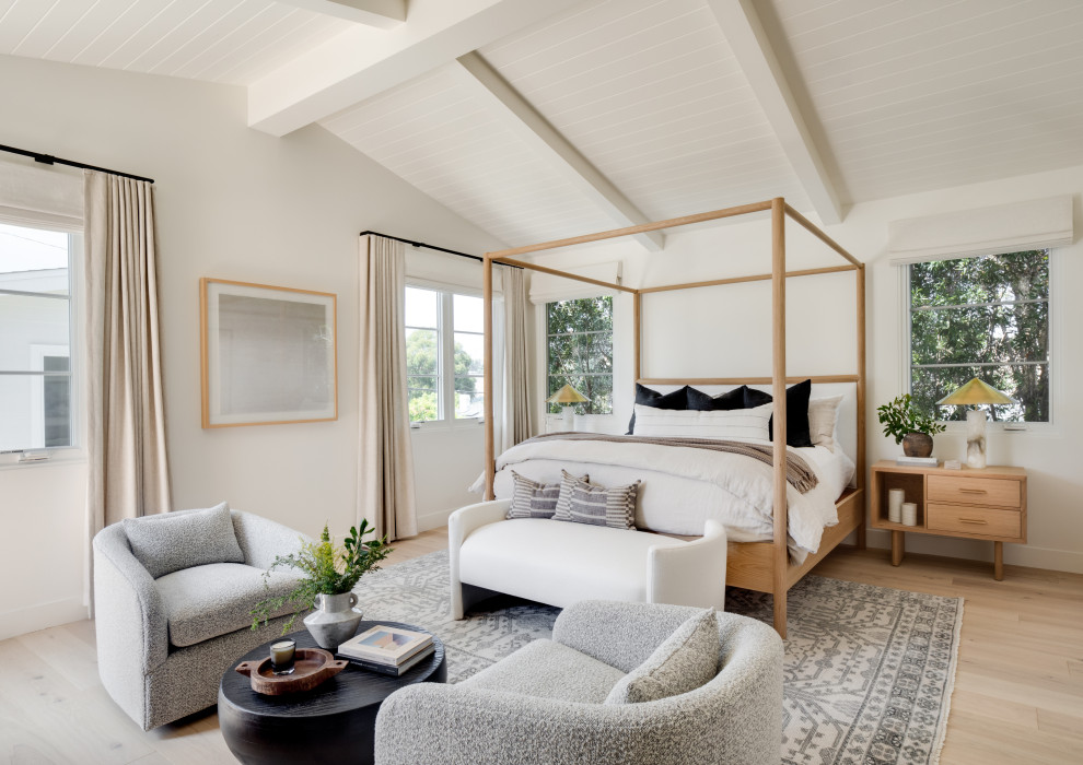 Beach style bedroom in Los Angeles with white walls, light hardwood floors, beige floor, exposed beam, timber and vaulted.