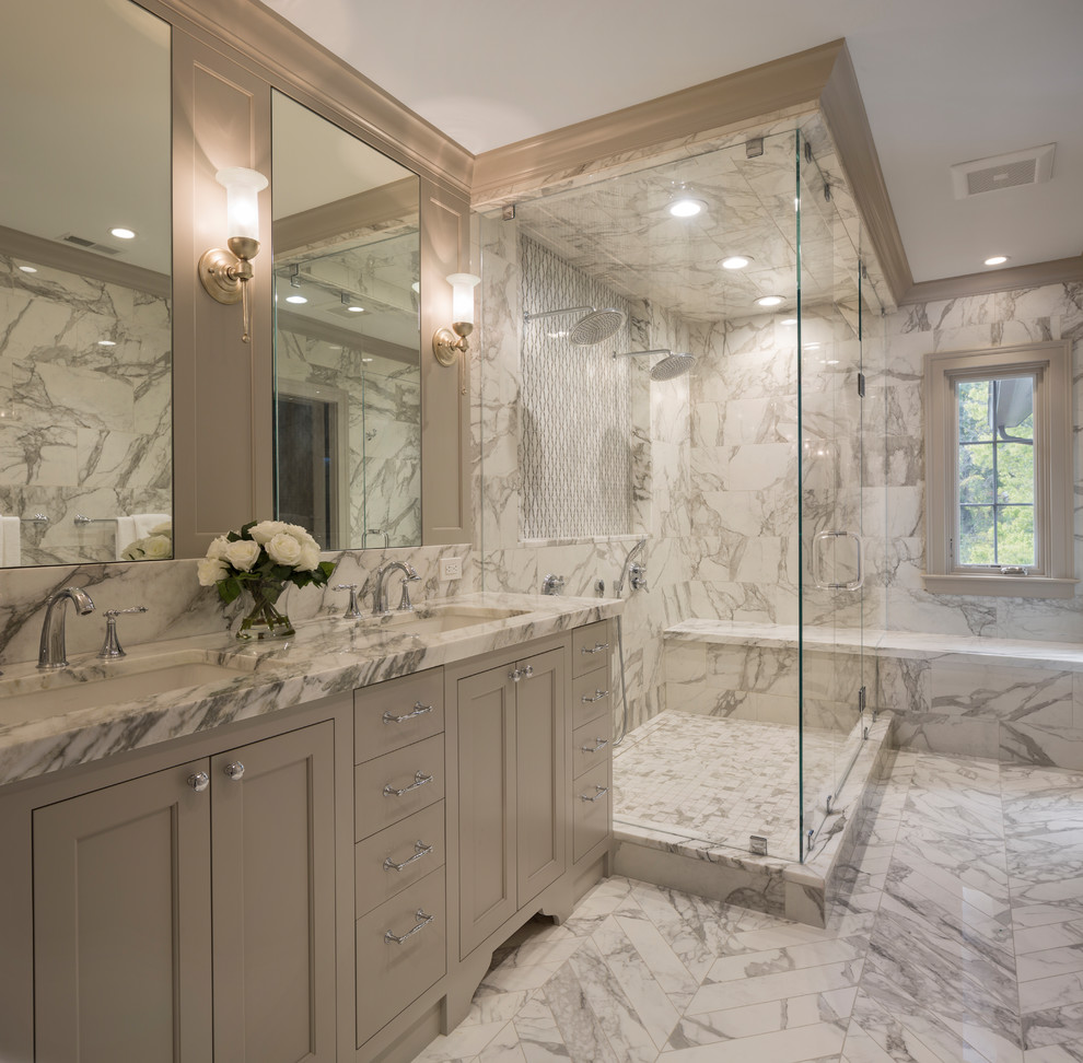 Photo of a traditional master bathroom in Cincinnati with recessed-panel cabinets, grey cabinets, a double shower, white tile, marble, an undermount sink, marble benchtops, white floor, a hinged shower door and white benchtops.