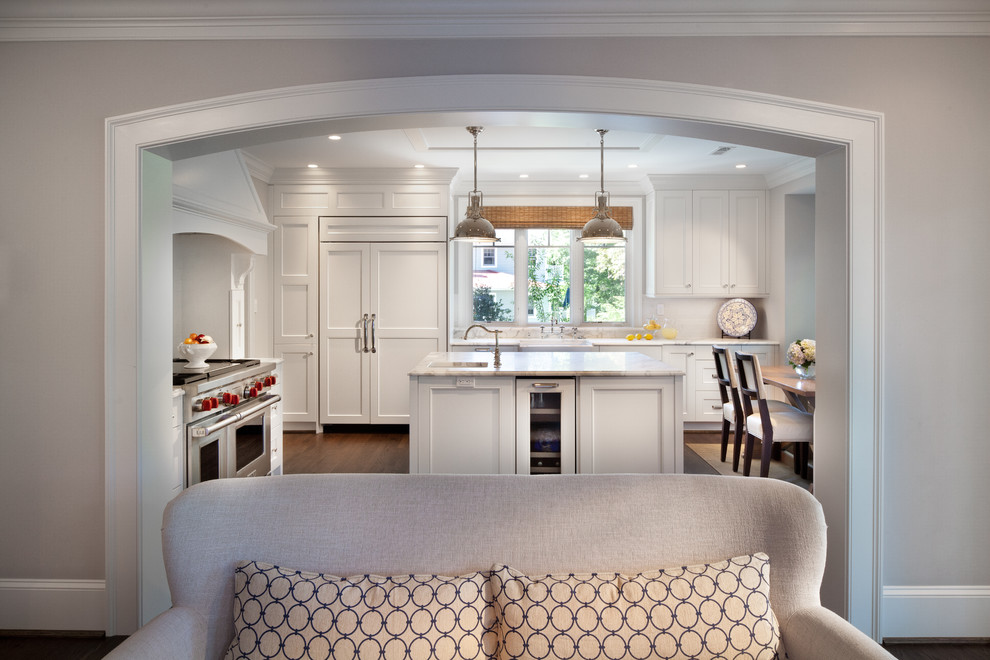 Transitional l-shaped eat-in kitchen photo in DC Metro with a farmhouse sink, recessed-panel cabinets, white cabinets, marble countertops, multicolored backsplash and paneled appliances