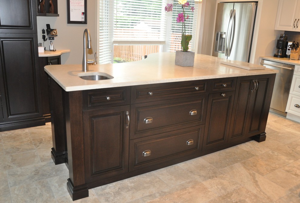 Open concept kitchen - large transitional l-shaped ceramic tile open concept kitchen idea in Toronto with an undermount sink, raised-panel cabinets, dark wood cabinets, stainless steel appliances and an island