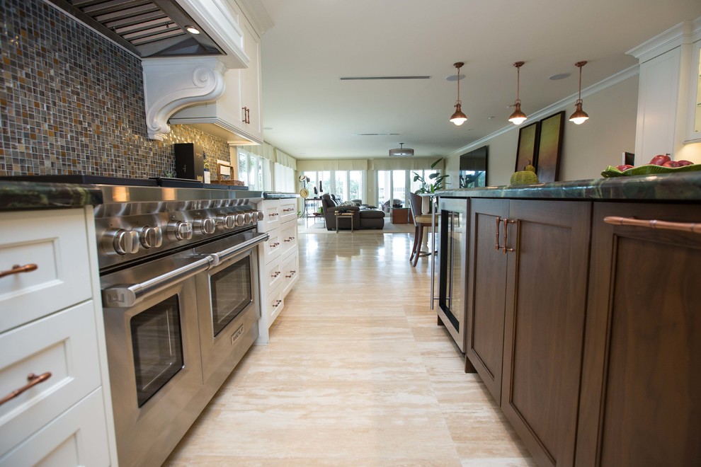 Open concept kitchen - transitional u-shaped open concept kitchen idea in Miami with a farmhouse sink, shaker cabinets, dark wood cabinets, stainless steel appliances and an island