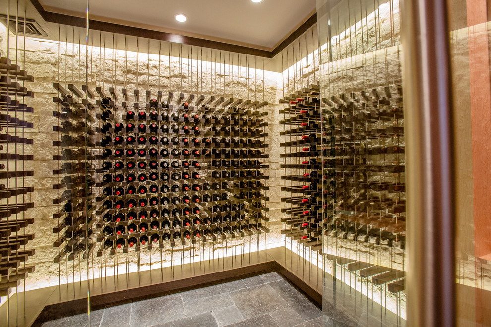 Mid-sized contemporary wine cellar in Boston with storage racks, travertine floors and grey floor.