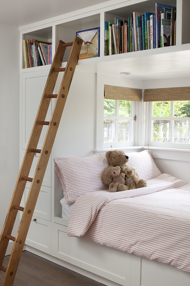 Photo of a transitional gender-neutral kids' bedroom for kids 4-10 years old in San Francisco with white walls and dark hardwood floors.