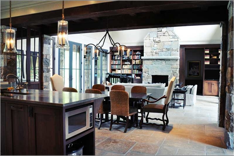 This is an example of a large country kitchen/dining combo in Other with beige walls and concrete floors.