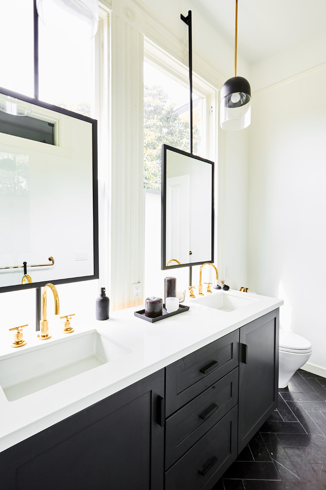 Mid-sized transitional master bathroom in San Francisco with shaker cabinets, black cabinets, an alcove shower, a one-piece toilet, white tile, porcelain tile, white walls, marble floors, an undermount sink, engineered quartz benchtops, black floor, a shower curtain and white benchtops.